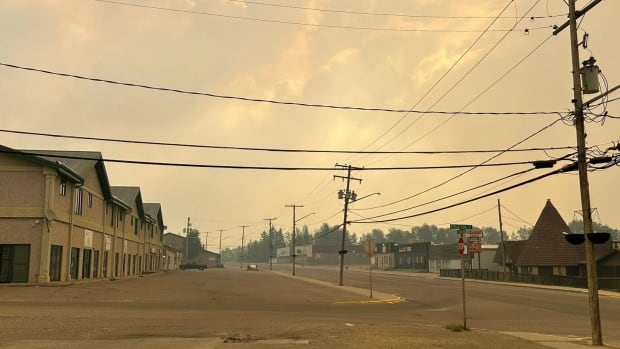 A town is covered in a haze of yellow smoke. 